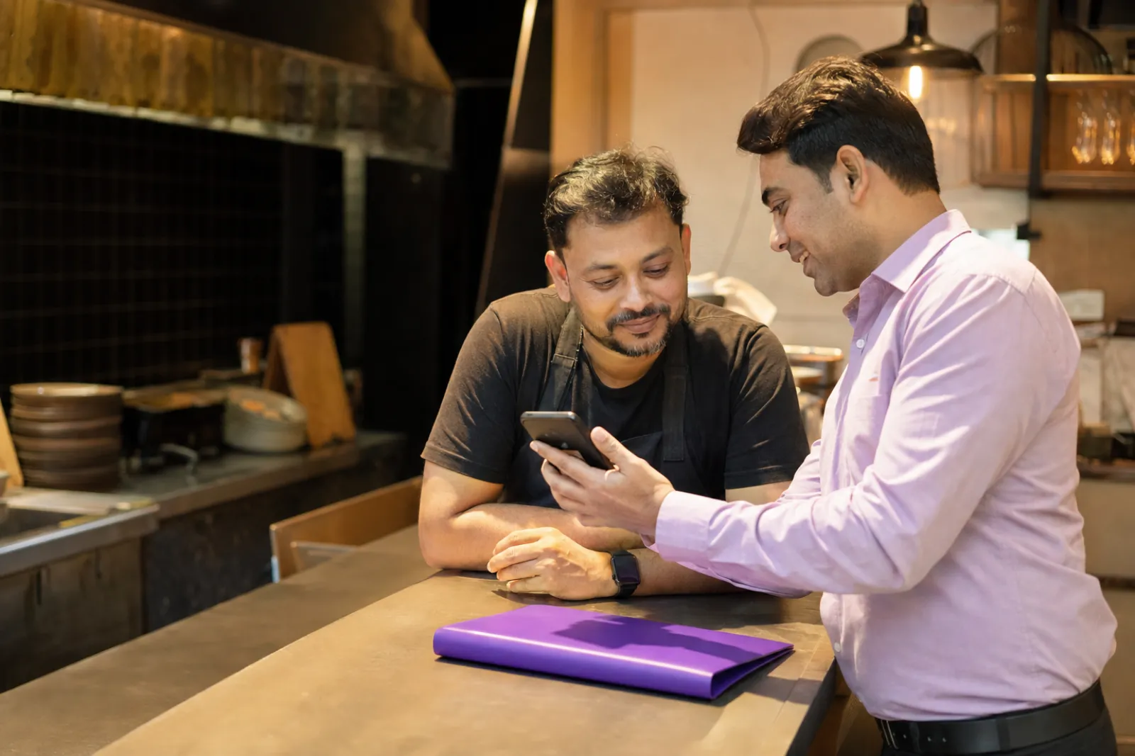 Rep showing the Boomerang demo to a restaurant owner